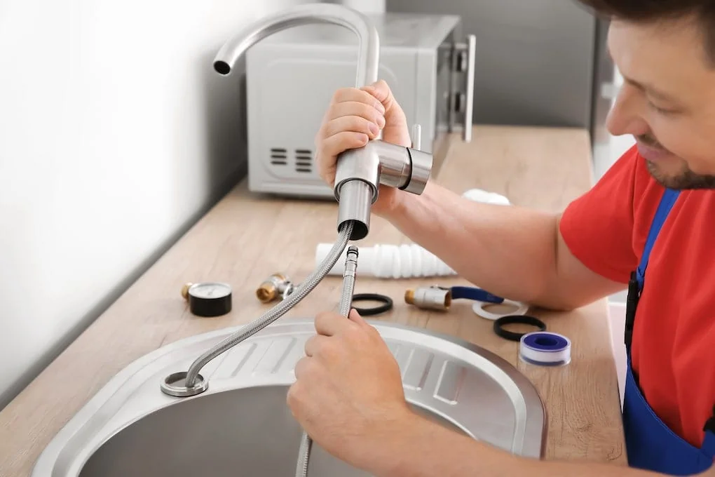 man showing how to install a kitchen sink