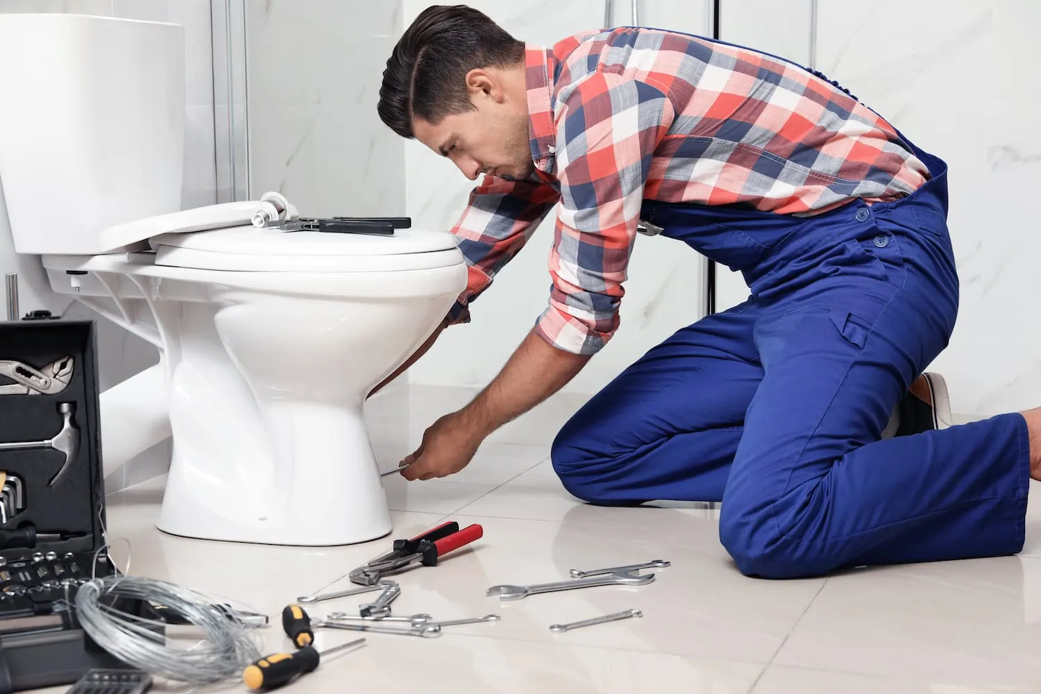 plumber installing a new toilet