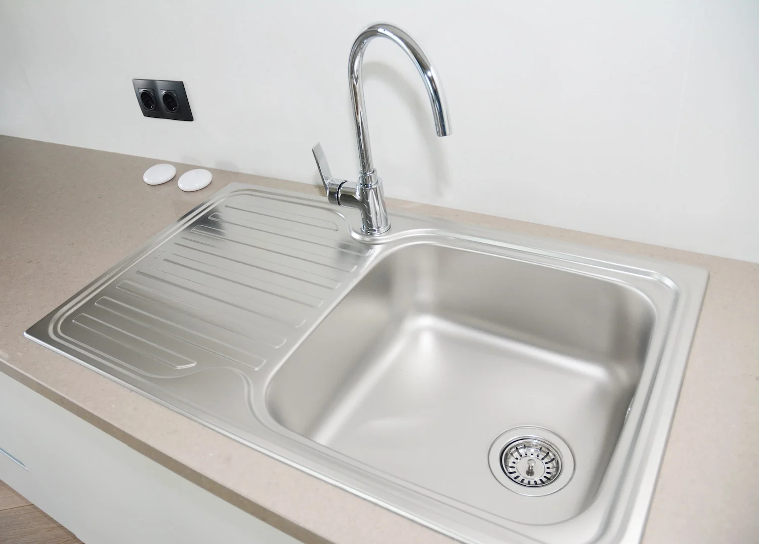 stainless steel drainboard sink is useful for prepping meals or drying dishes