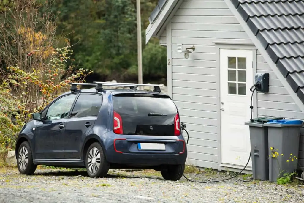 electric vehicle plugged into home charging station
