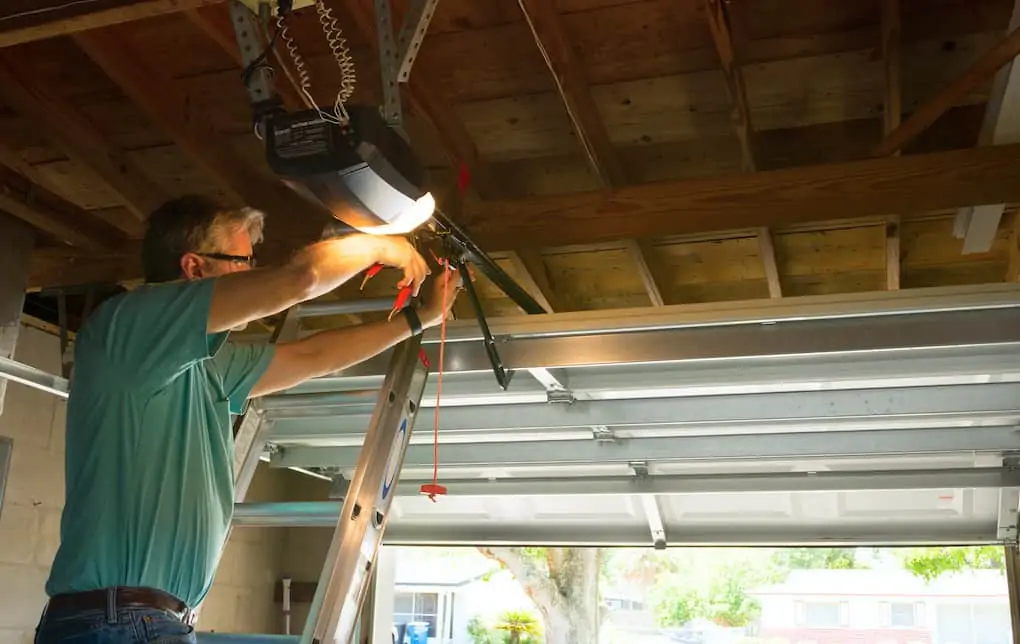 man wiring a garage door opener