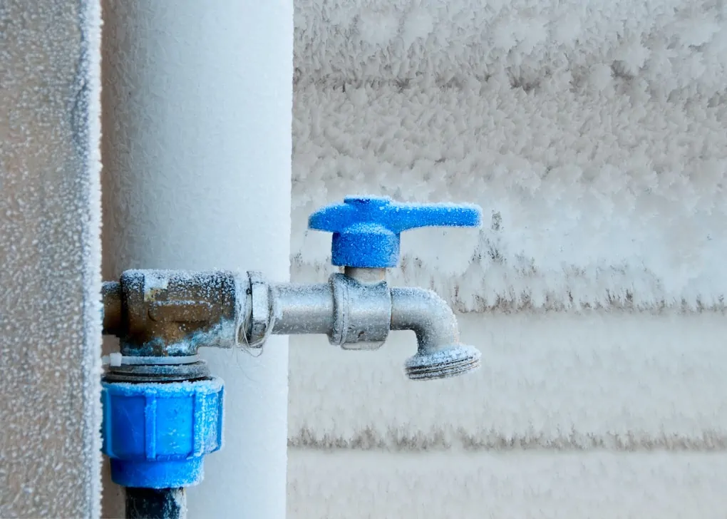 Frozen faucet in winter; outdoor faucet types