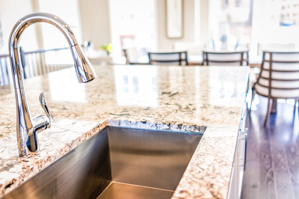 Types of kitchen sinks - undermount sink on a marble granite countertop