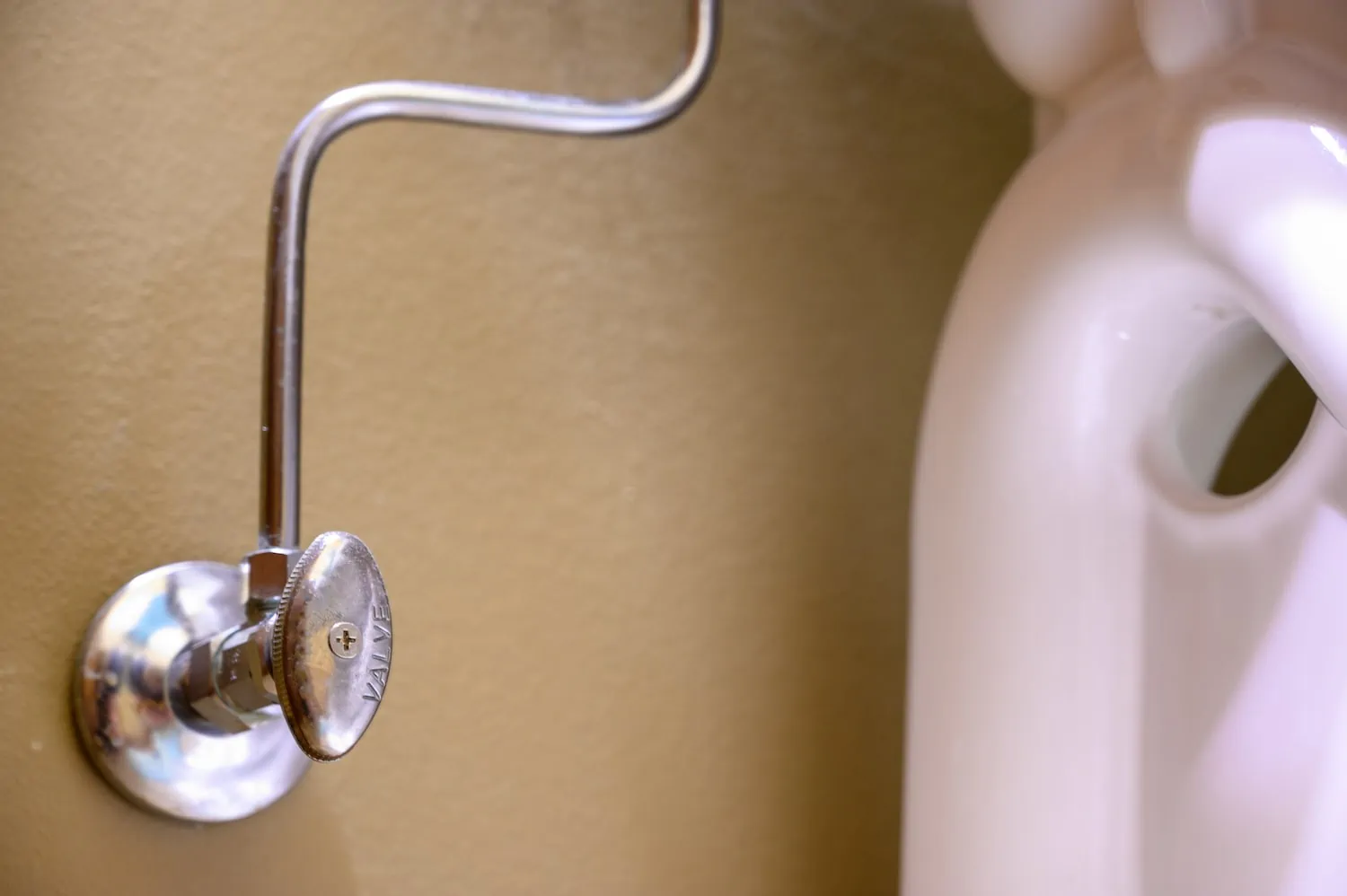 water shut off valve behind toilet