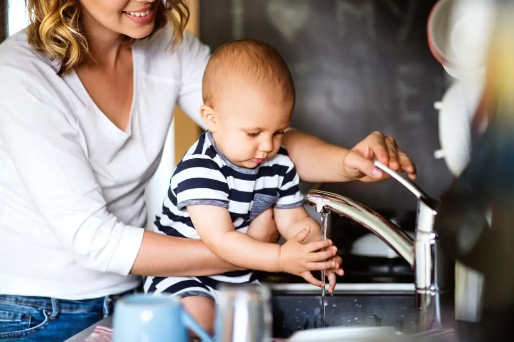 mom and baby at sink