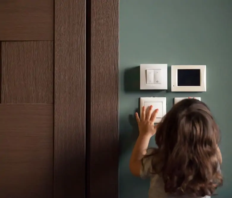 little girl looking at modern electrical controls; electrical panel upgrade