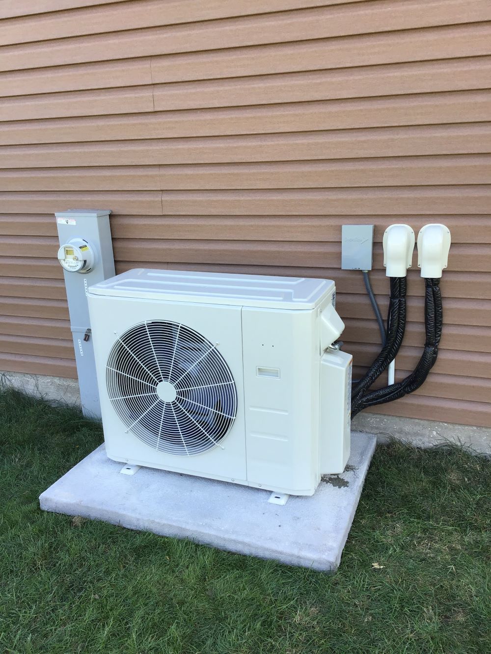 Ductless heat pump system on the exterior of a house