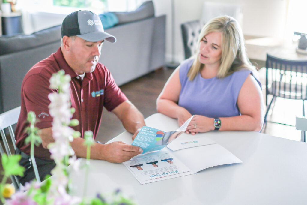 4Front Energy technician discussing HVAC estimate with Minnesota homeowner