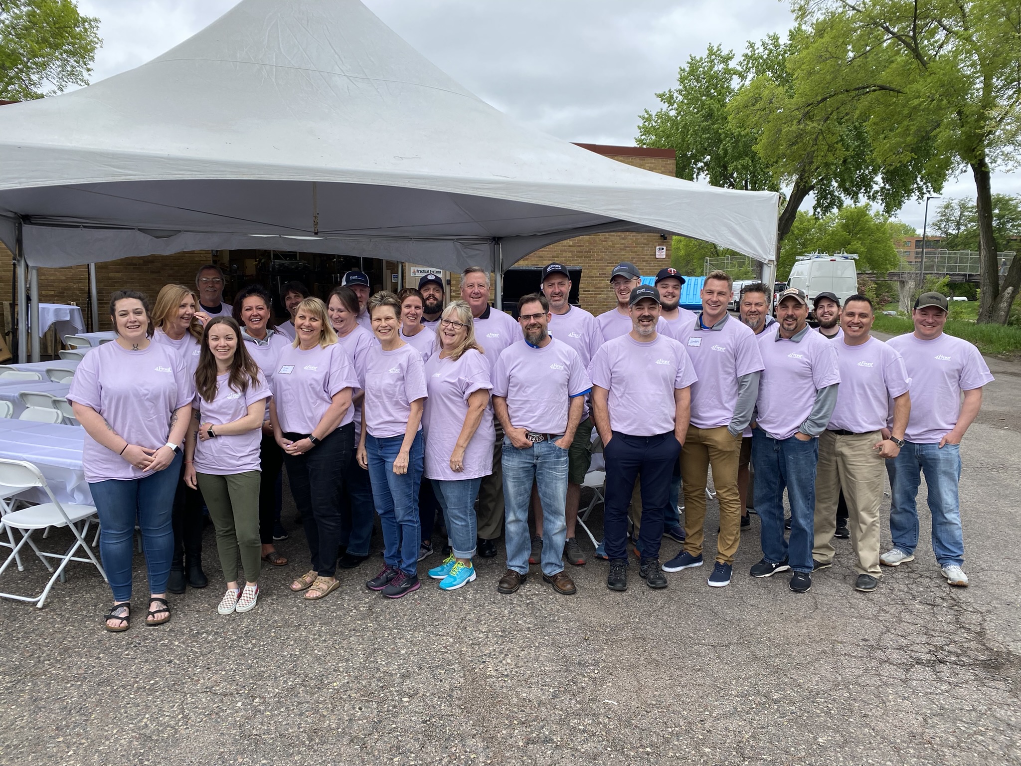 Current picture of 4Front employees wearing matching purple shirts