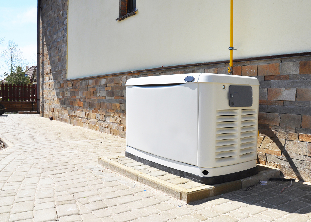 Whole-home generator installed on the side of a building