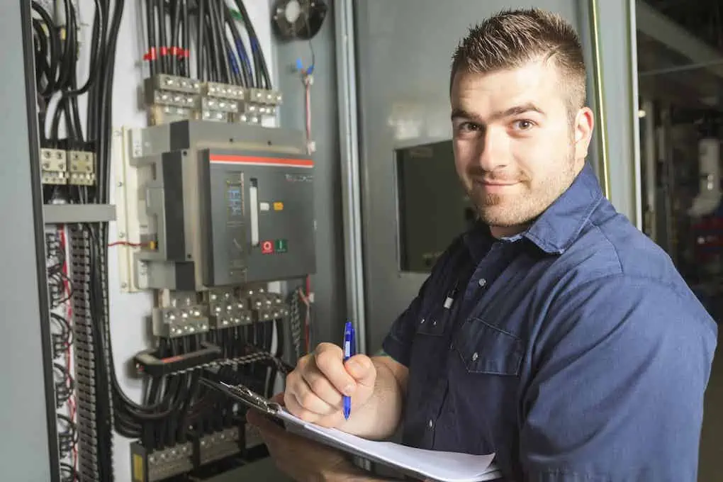 Portrait of a happy electrician working on electrical panel upgrade