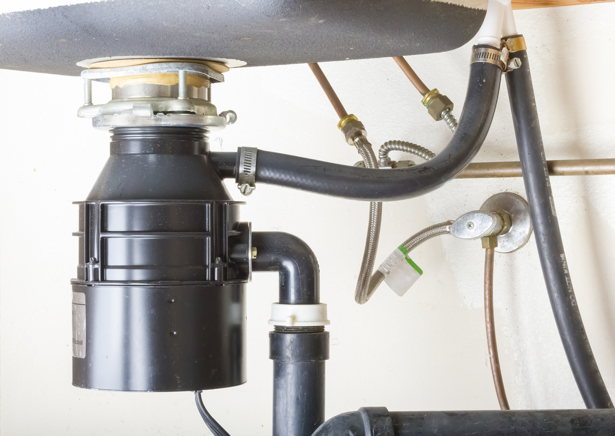 Newly installed garbage disposal under kitchen sink