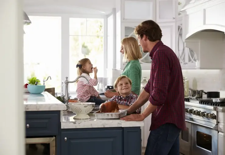 A happy family in their newly remodeled kitchen