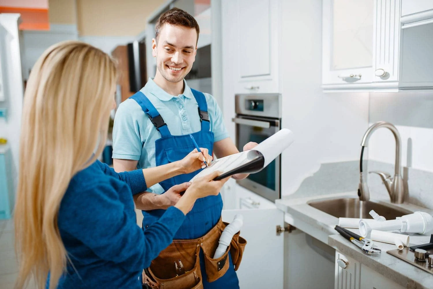 Male plumber and female customer in the kitchen; history of st. paul