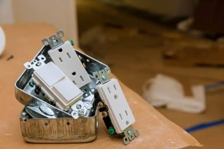 box of new electrical outlets on table; home electrical inspections