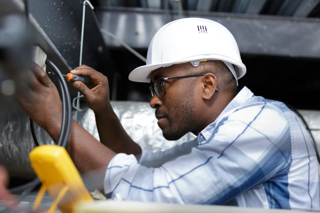 electrician fitting a cable; diy electrical