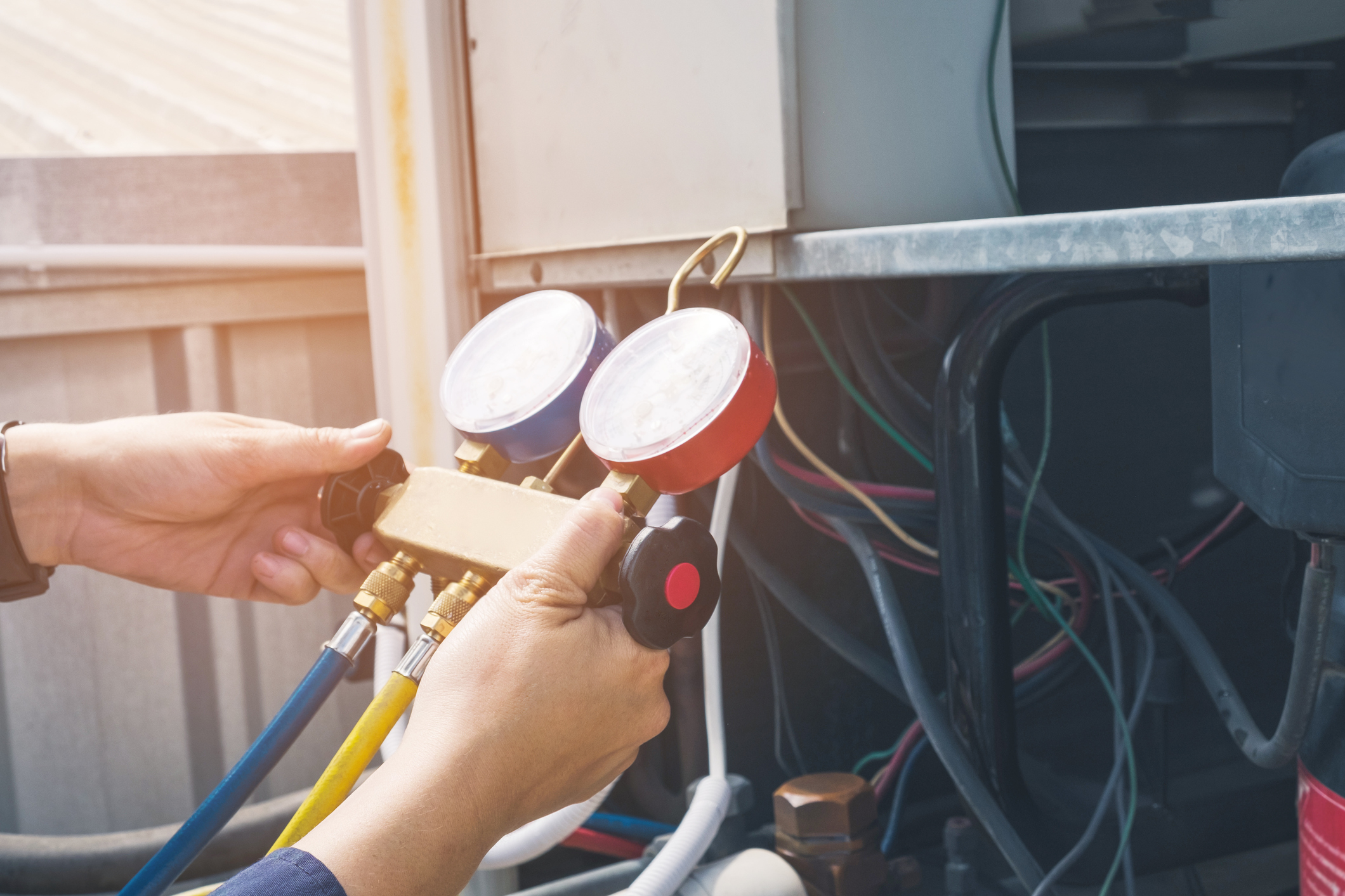 HVAC technician using a pressure gauge