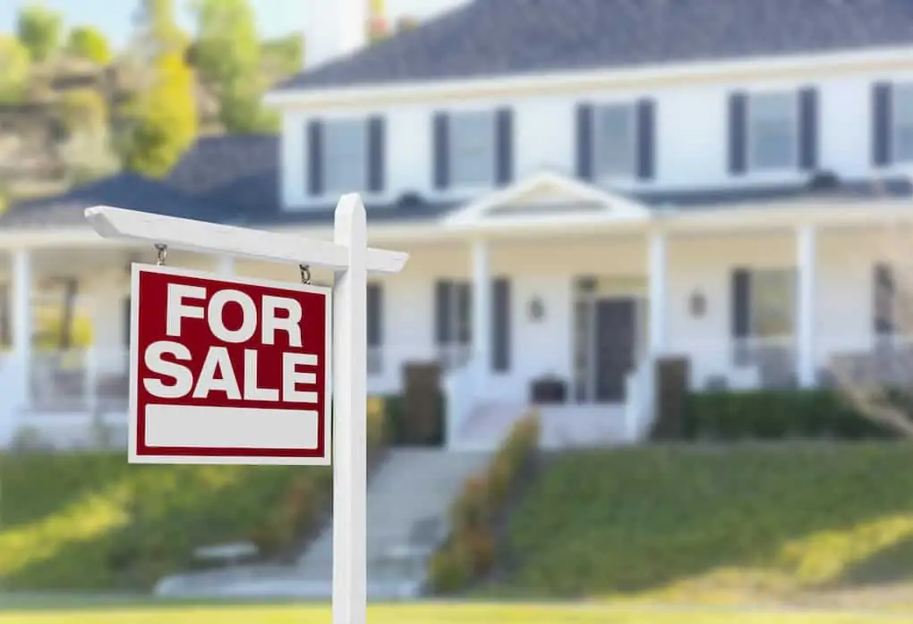 for sale sign in front of home