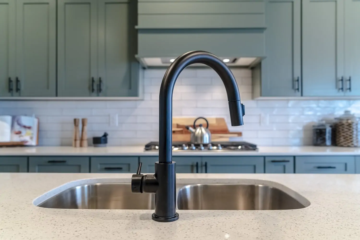 A silver sink with a black faucet in the kitchen